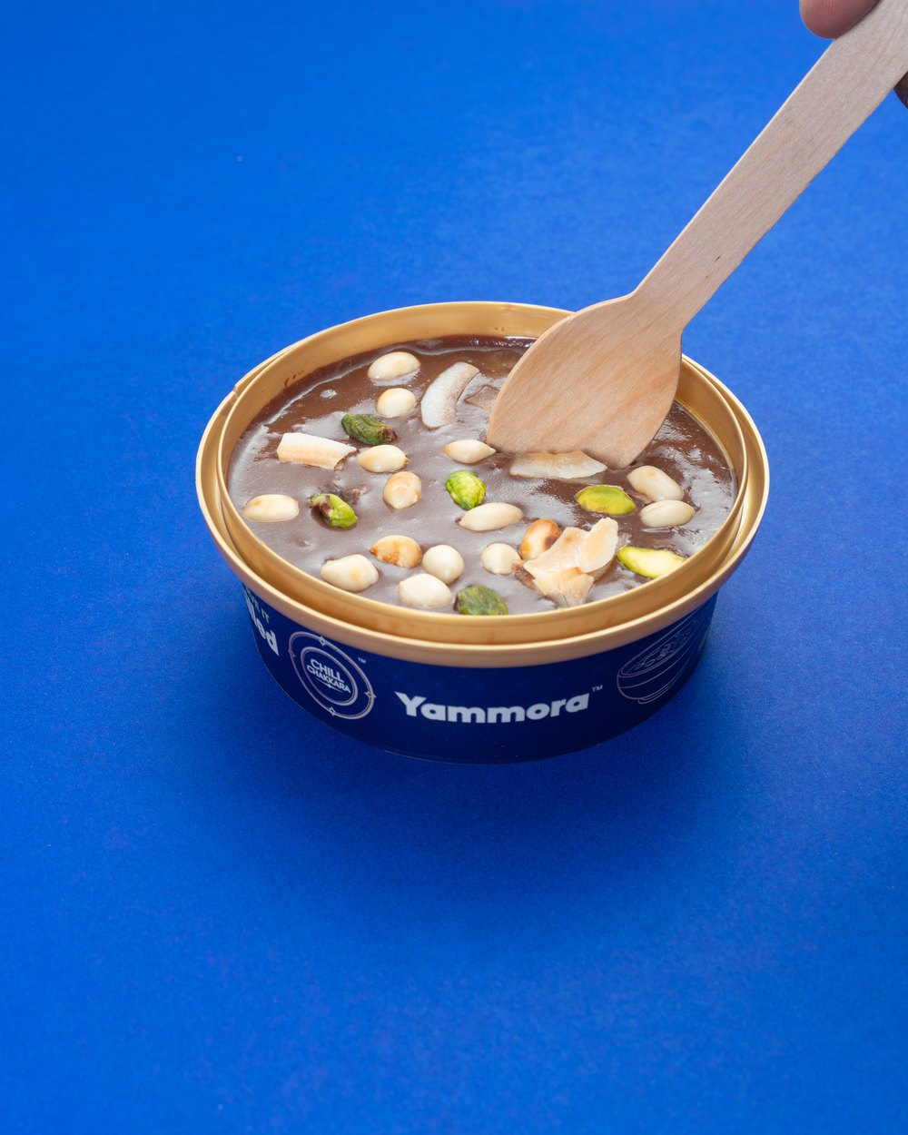 Digging into a Yammora chilled dessert with a wooden spoon